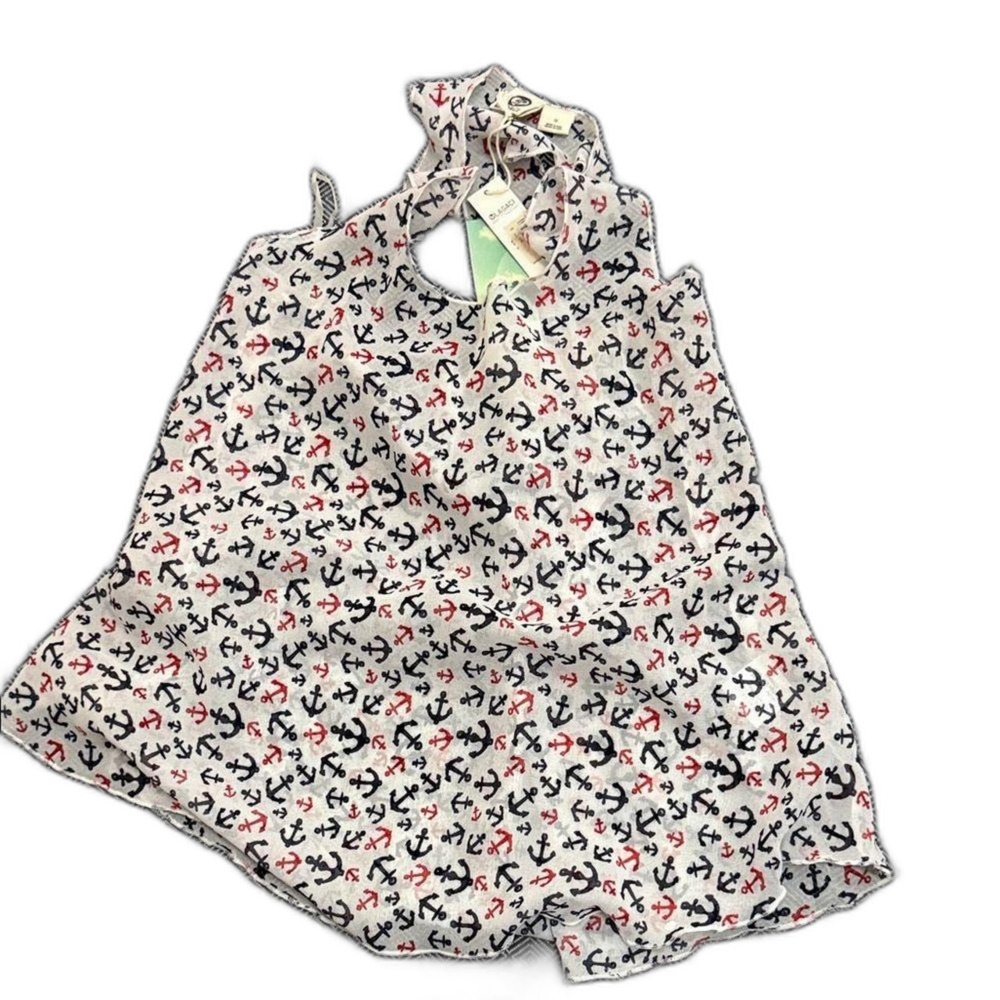 Chic top with nautical anchor design. Features red, blue, and white colors.